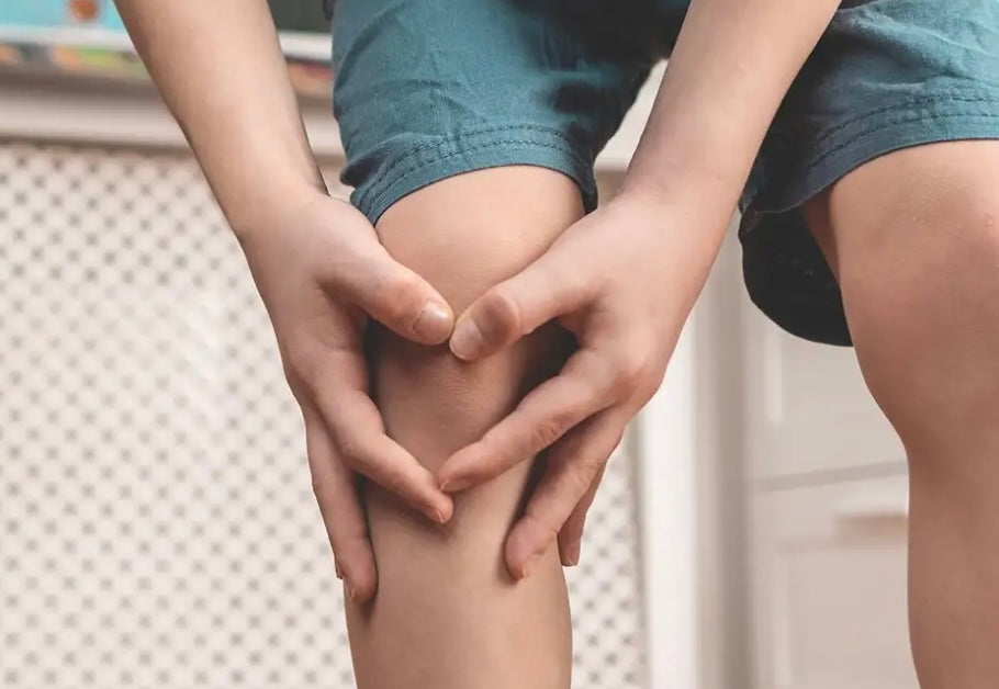 A kid having common but painful growing pains in their legs.